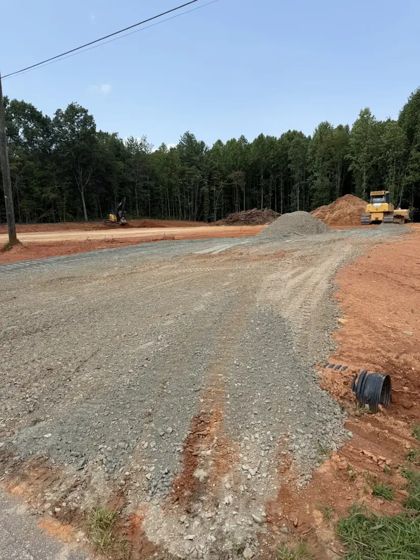 Gravel driveway entrance with culvert off a paved road