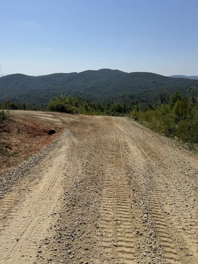 Finished gravel driveway with a culvert and mountain view